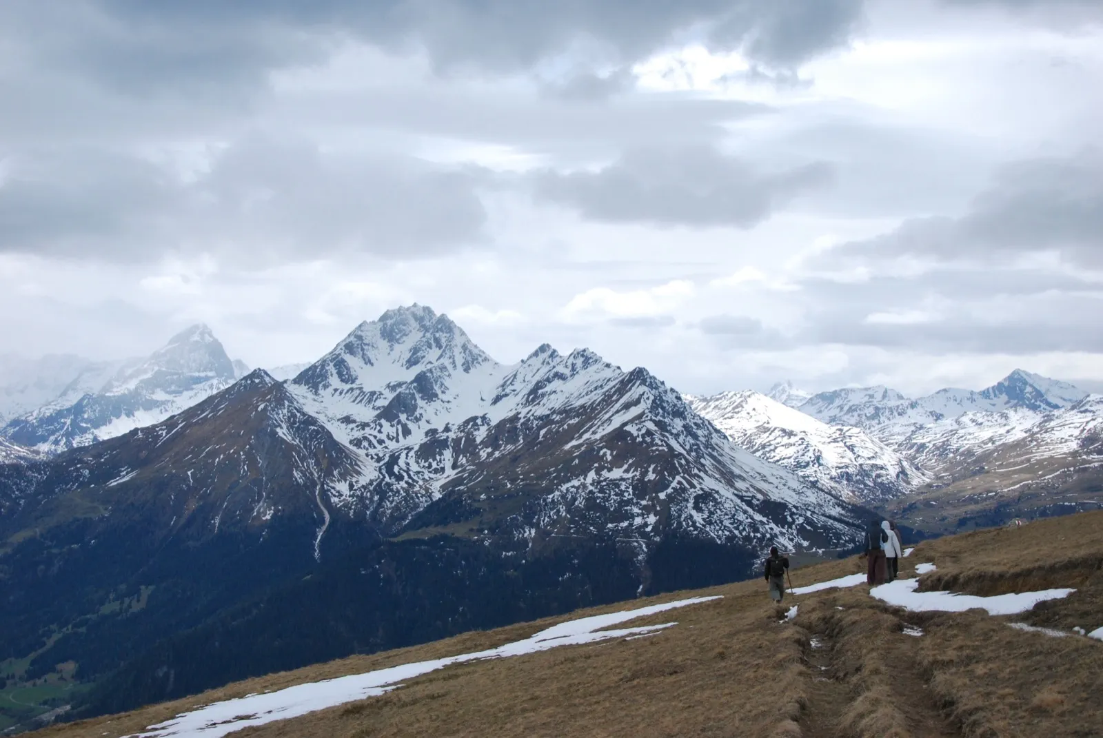Two hikers on a mountain path in the Swiss Alps