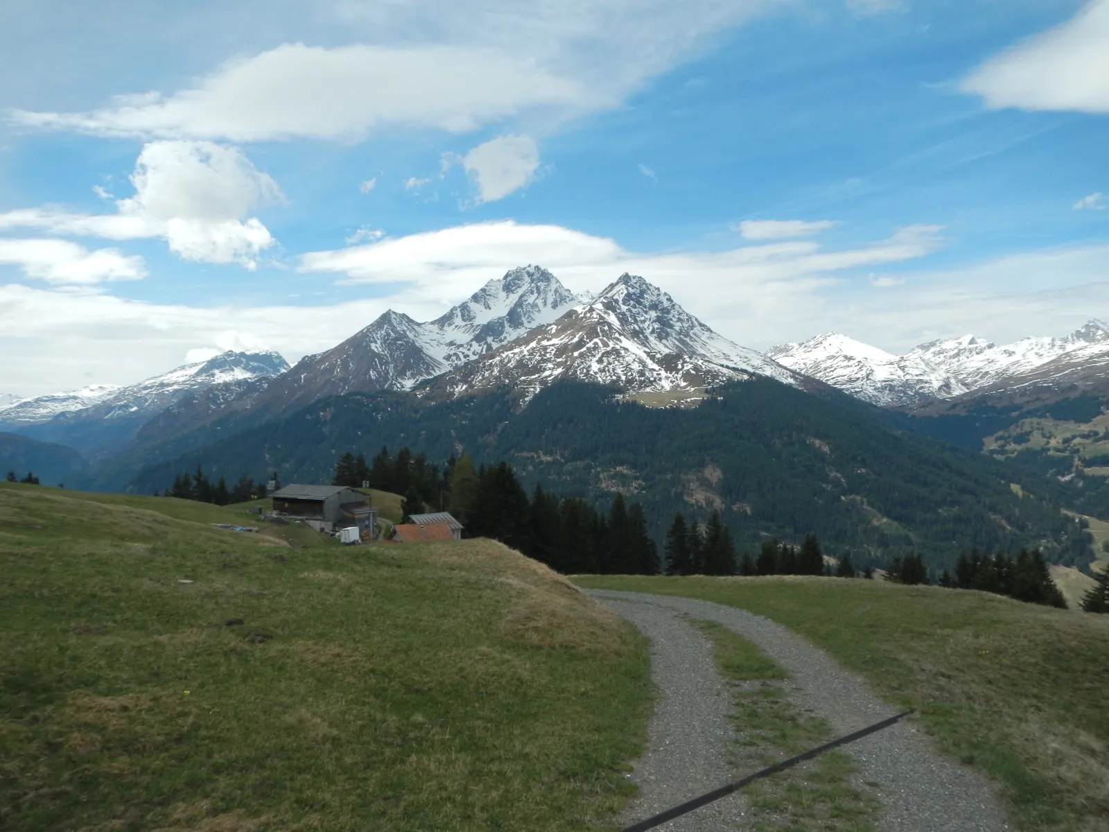 Gravel path leading toward snow covered peaks in Switzerland